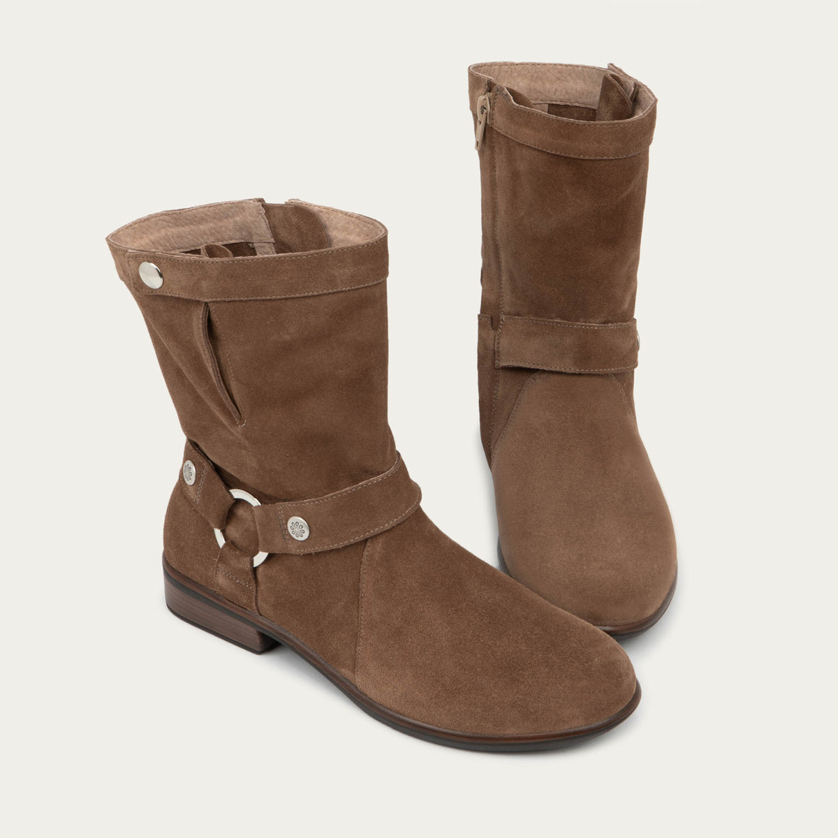 Pair of brown suede mid-calf boots with decorative t-strap and buckle, side zipper, rounded toe, and low stacked heel