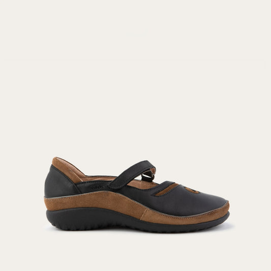 Profile view of a brown and black Mary Jane on a textured sole.