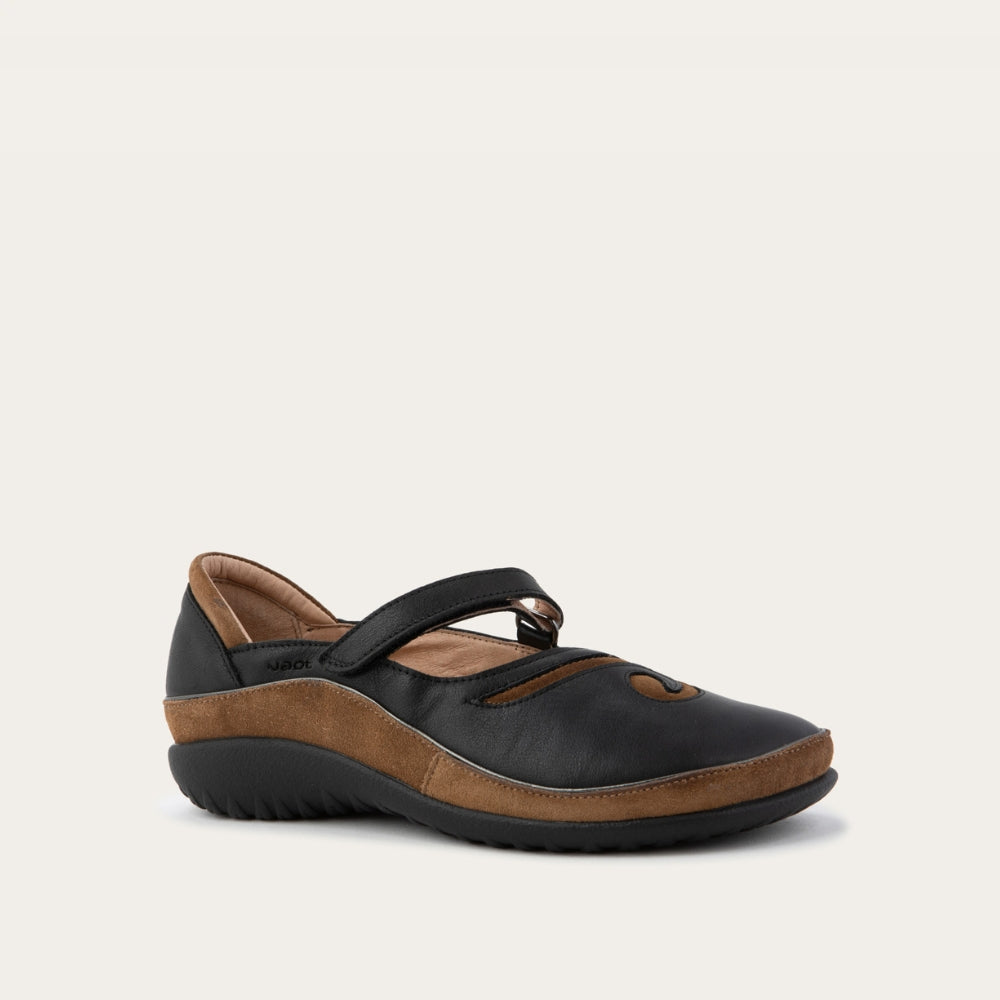 Angled profile view of a brown and black Mary Jane on a textured sole.