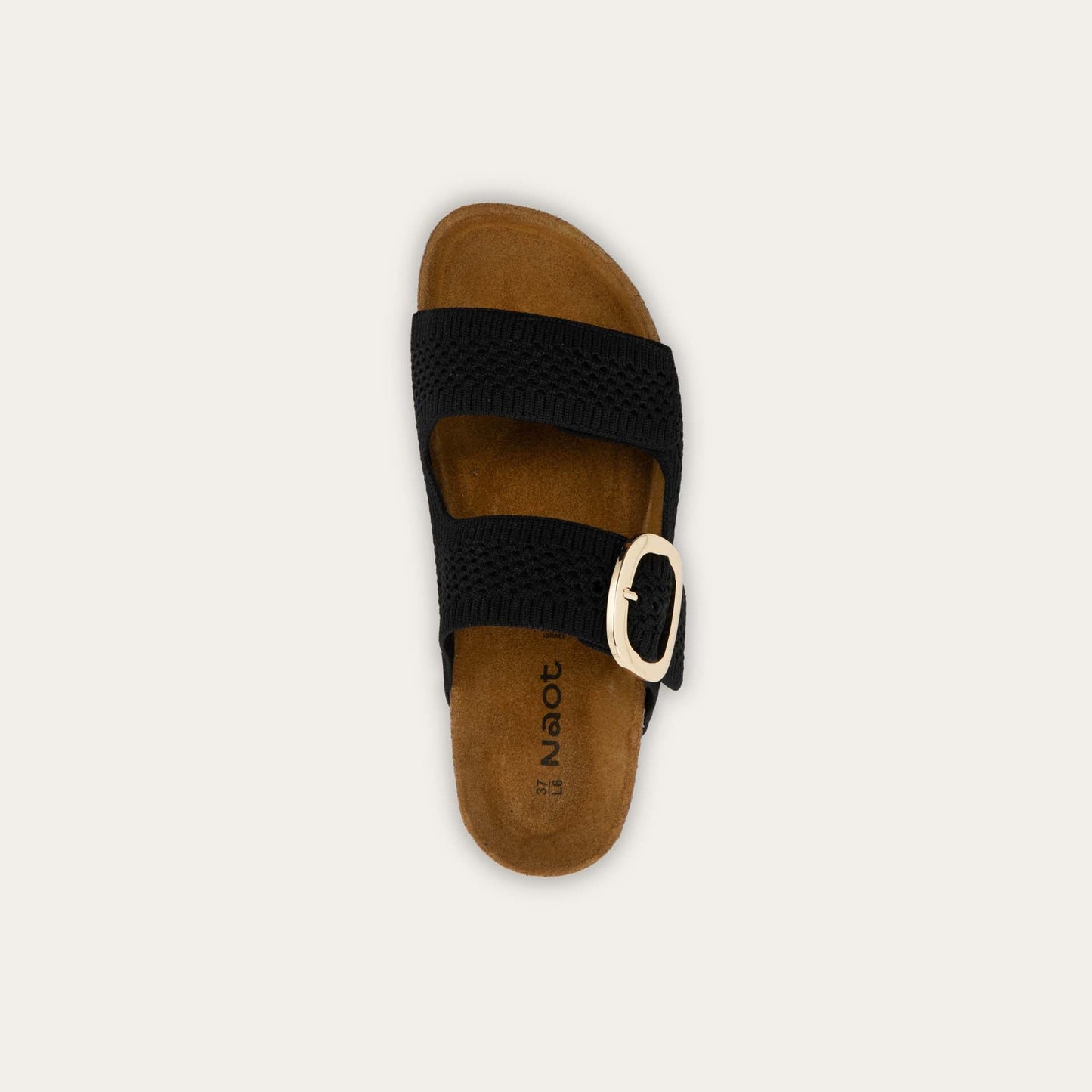 Top view of a black slip-on sandal with two adjustable knit straps and a large gold buckle. It has a cork footbed and a black sole.