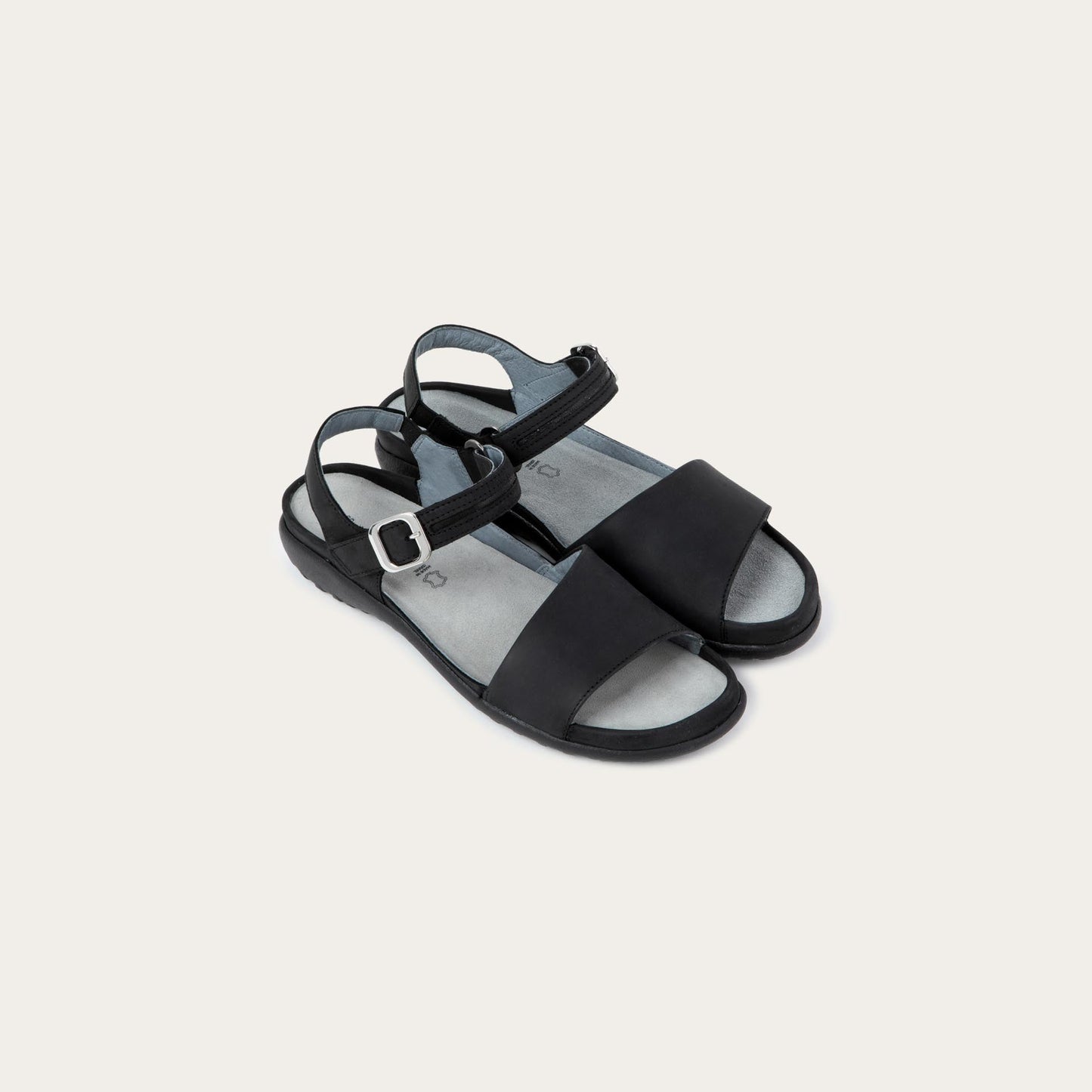 Pair of  black, open toe sandals, featuring a toe strap and asjustable ankle strap with a silver accent buckle.