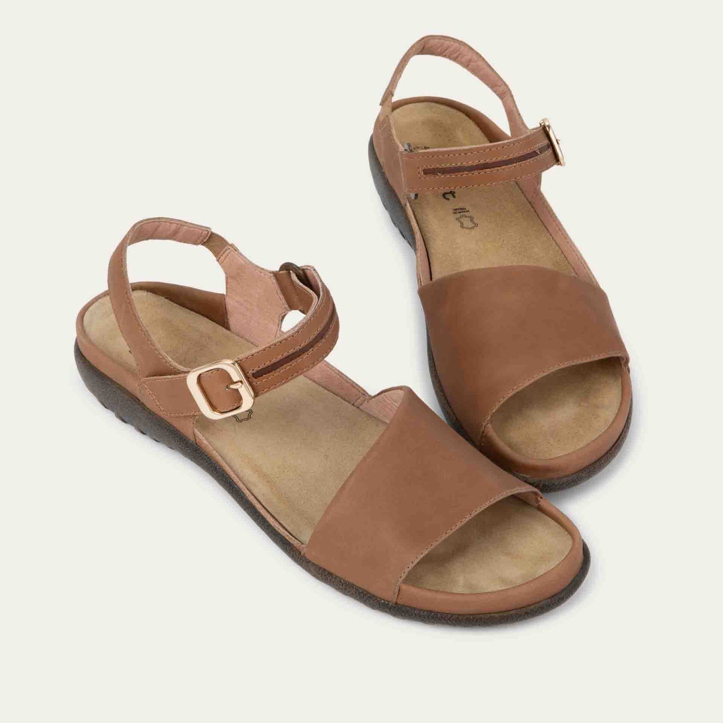 Pair of  brown, open toe sandals, featuring a toe strap and asjustable ankle strap with a silver accent buckle.