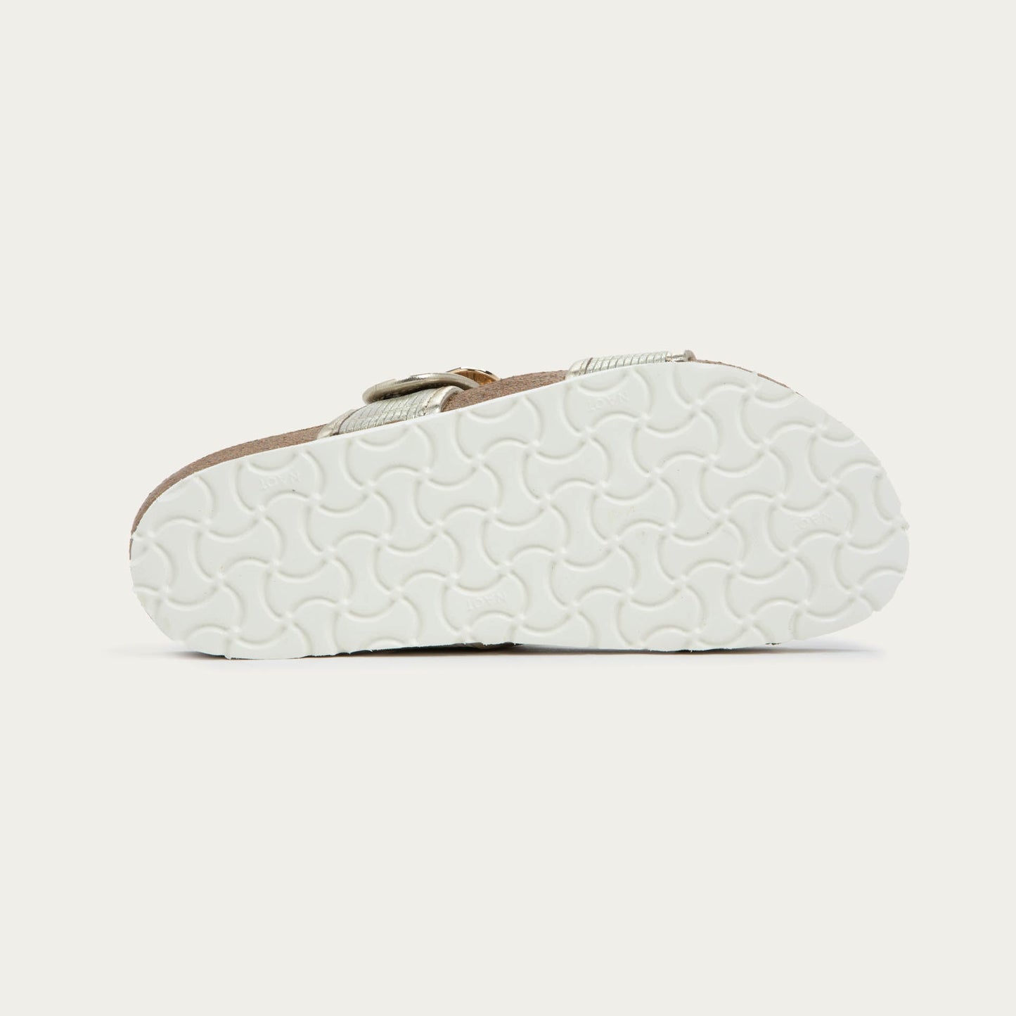 Bottom view of a metalic beige slide with two adjustable straps featuring gold buckles,  cork footbed and, white sole