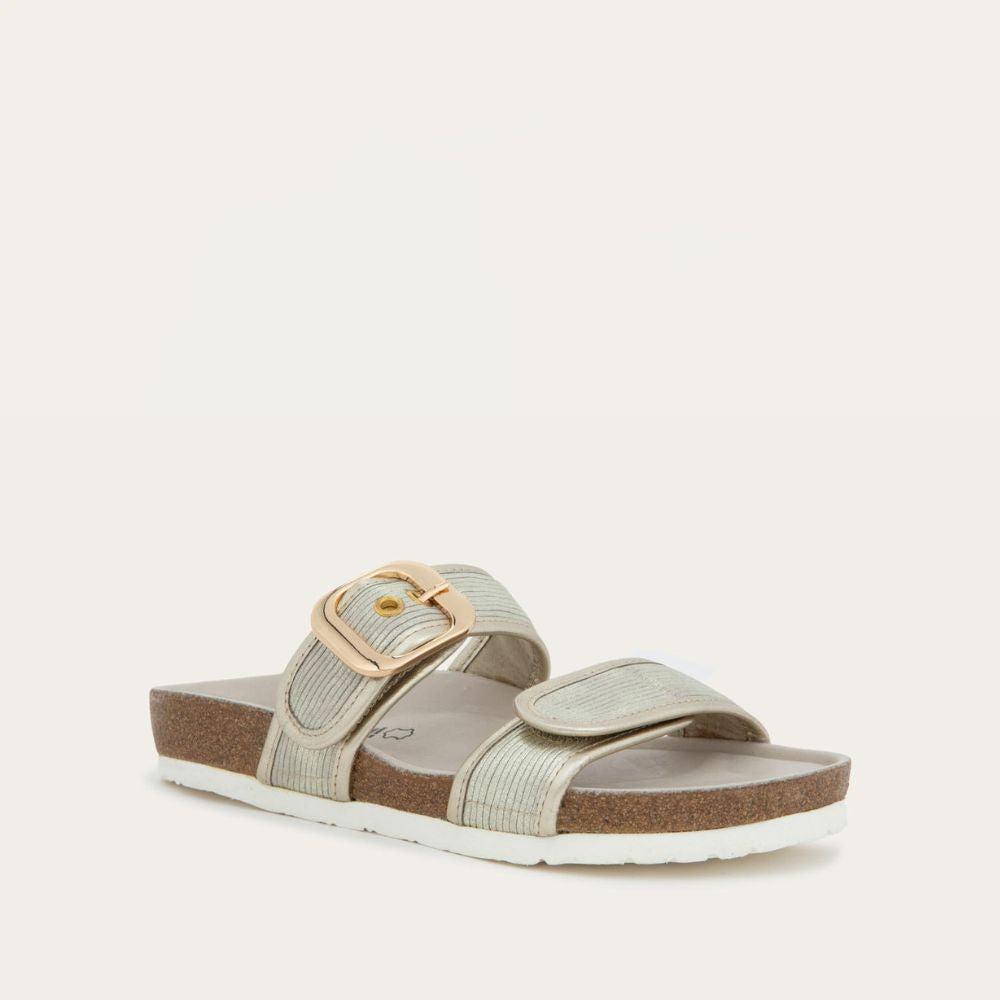 Angled profile view of a metalic beige slide with two adjustable straps featuring gold buckles,  cork footbed and, white sole