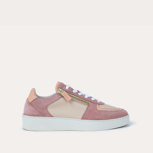 Profile view of a multicolored pink and white sneaker with laces and a side zipper.