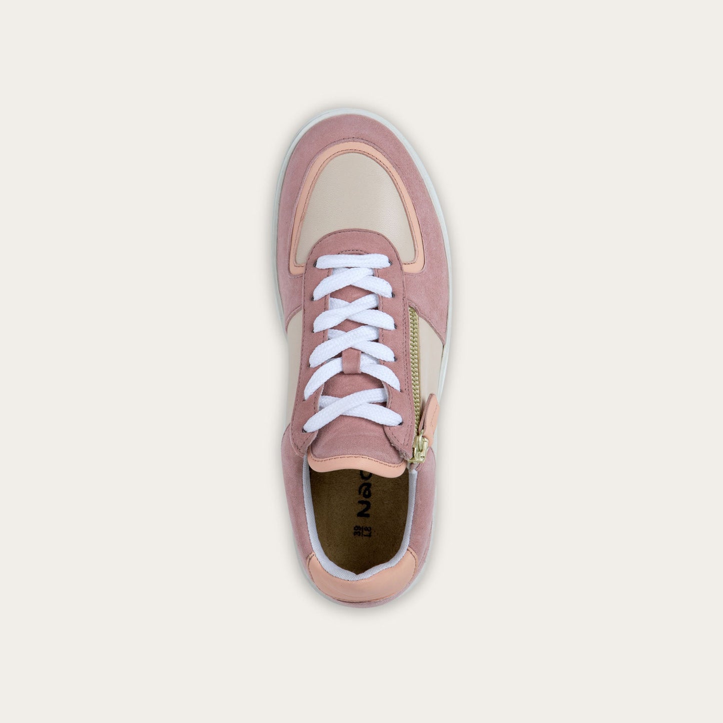 Top view of a multicolored pink and white sneaker with laces and a side zipper.