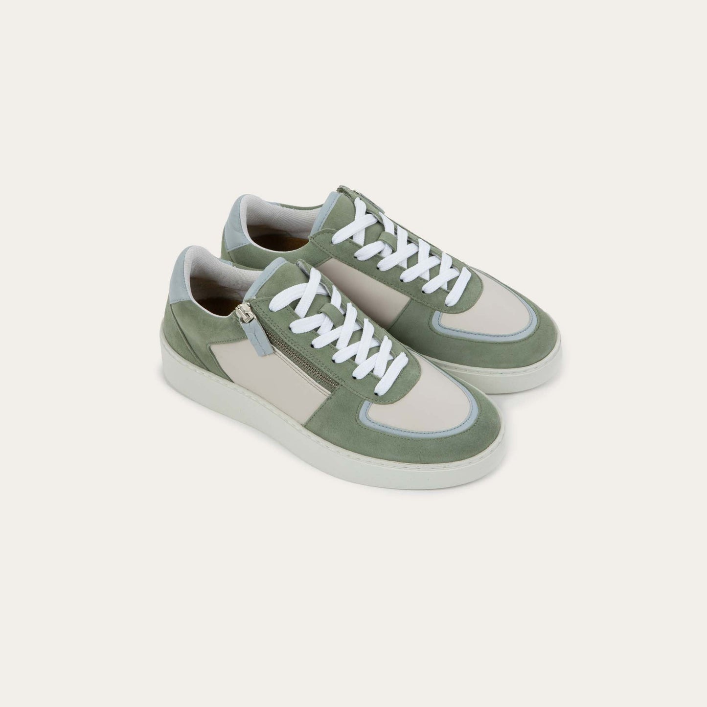 Pair of multicolored green and white sneakers with laces and a side zipper.