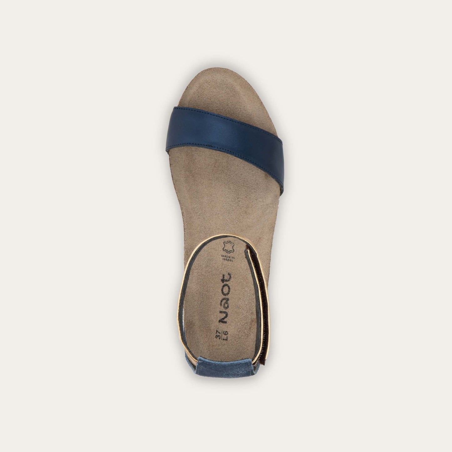 Top view of a blue wedge sandal with cork sole, featuring an open toe and metallic gold ankle strap.