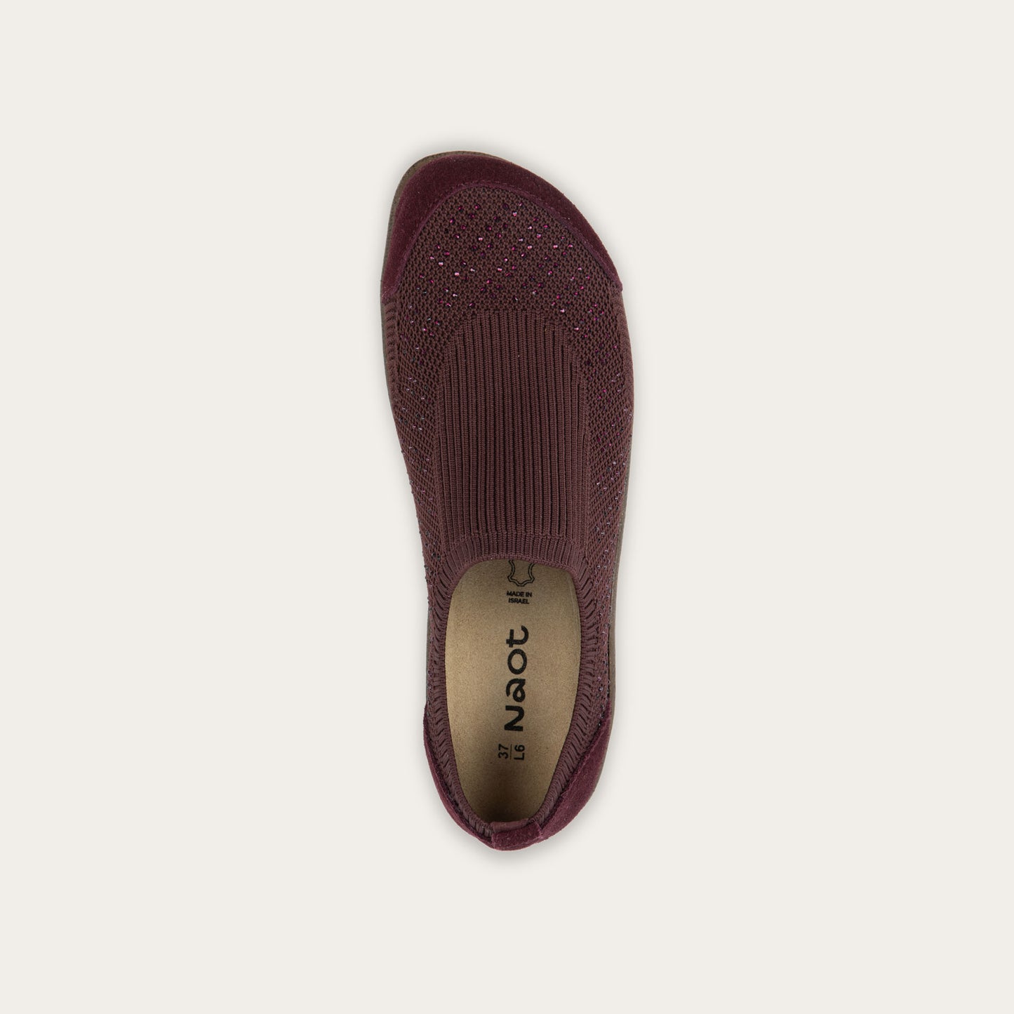 Top view of a purple knit slip on shoe with rivet accents throughout.