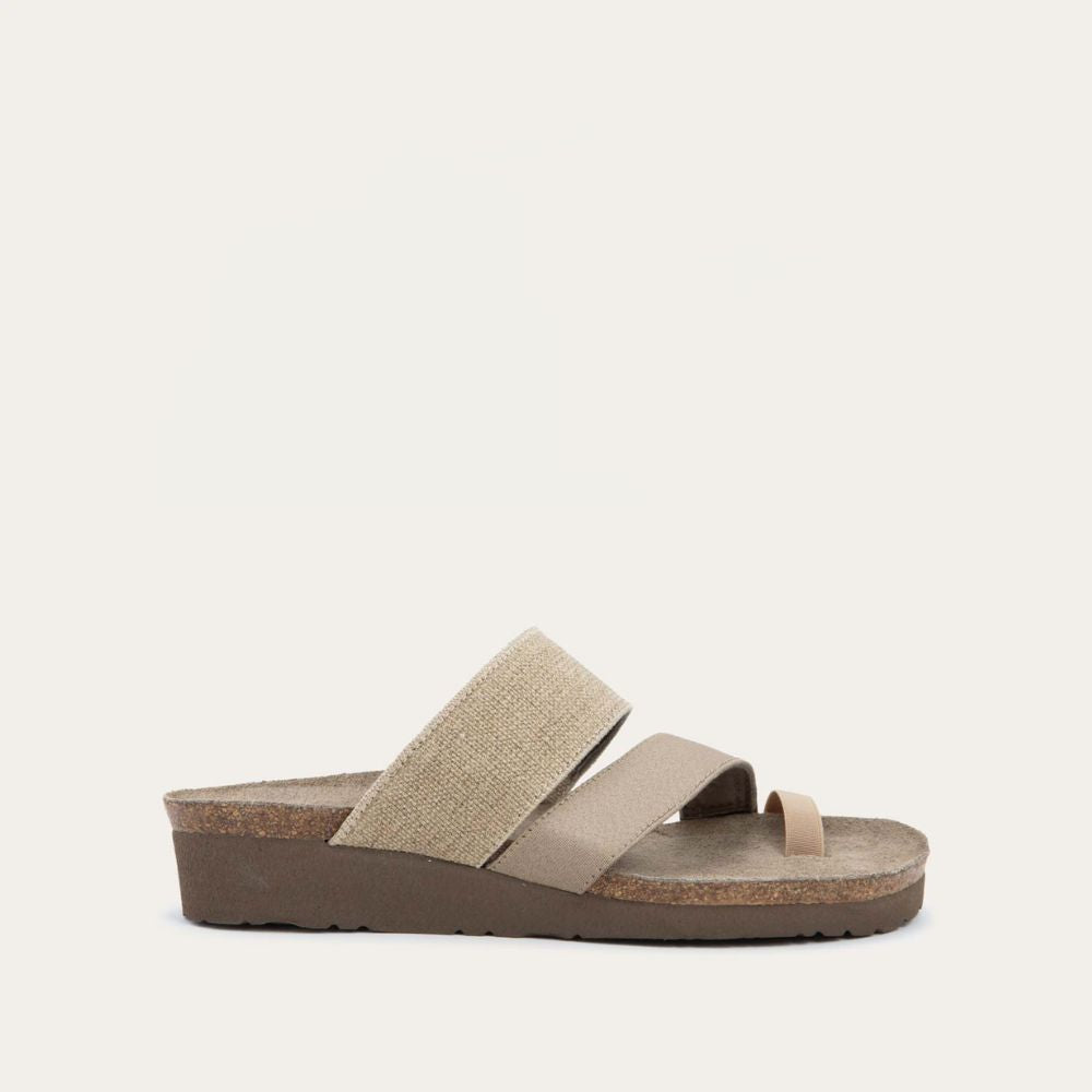 Profile view of beige, multi-strap, sling-back sandal with a cork footbed.