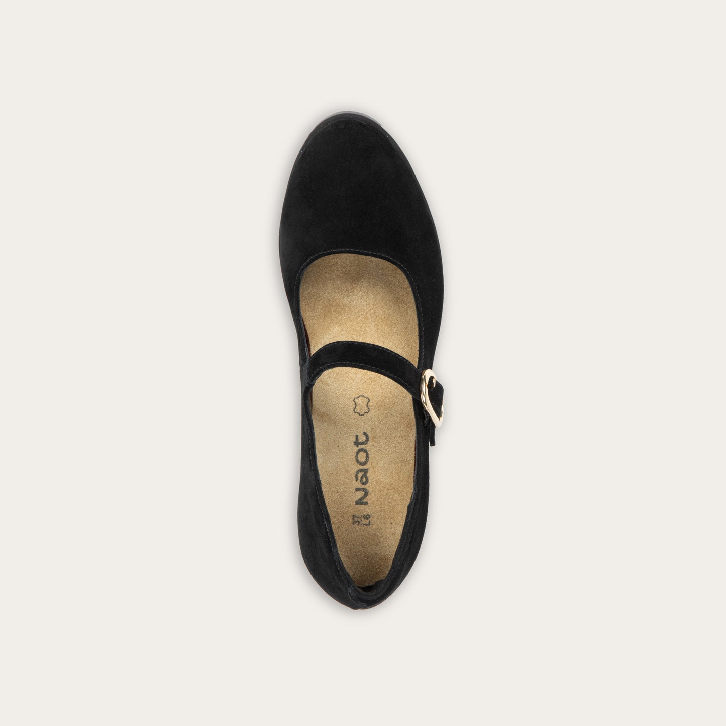 Top view of a black suede Mary Jane shoe with a rounded toe, a low block heel, and a thin strap across the instep secured by a polished gold-tone metal buckle.