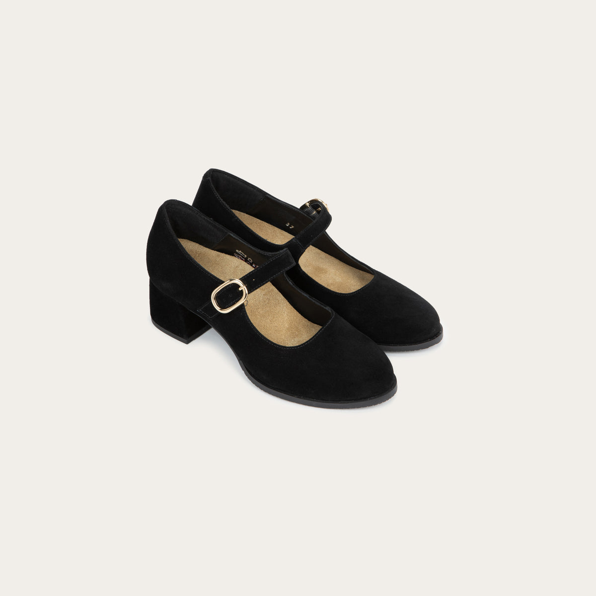 A pair of of black suede Mary Jane shoes with rounded toes, low block heels, and thin straps across the insteps secured by polished gold-tone metal buckles.