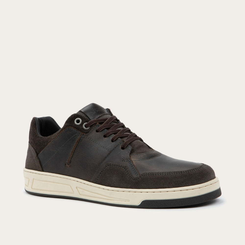 Angled view of a gray sneaker with brown accents on a white sole.