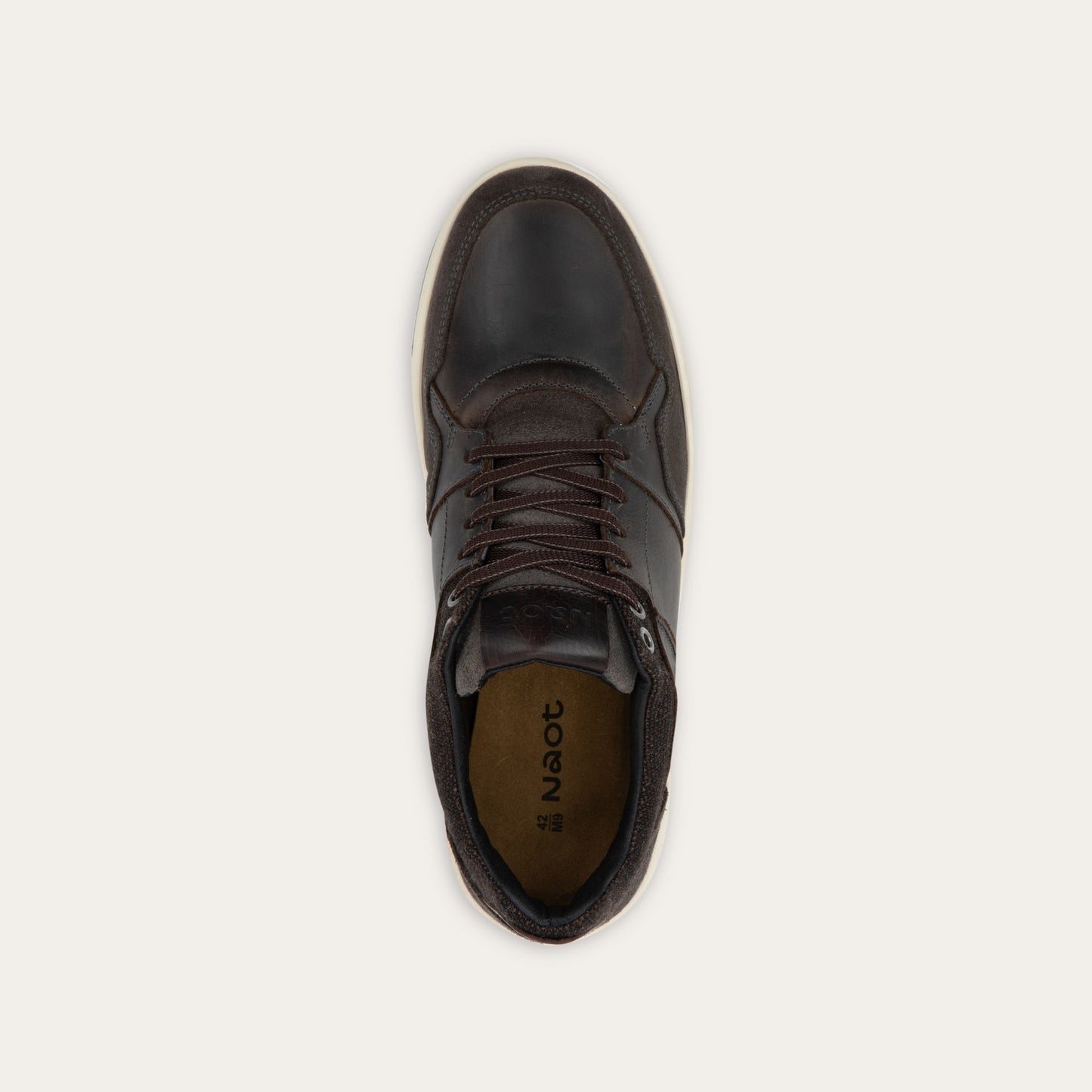 Top view of a gray sneaker with brown accents on a white sole.