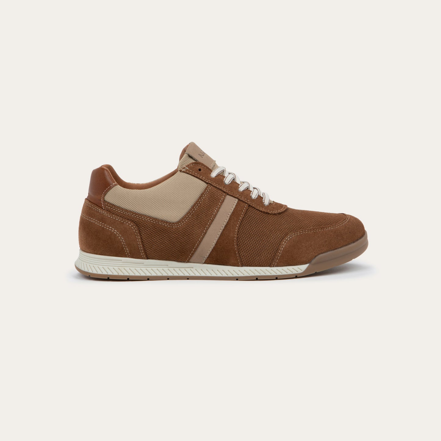 Profile view of a brown and beige sneaker on a brown sole.