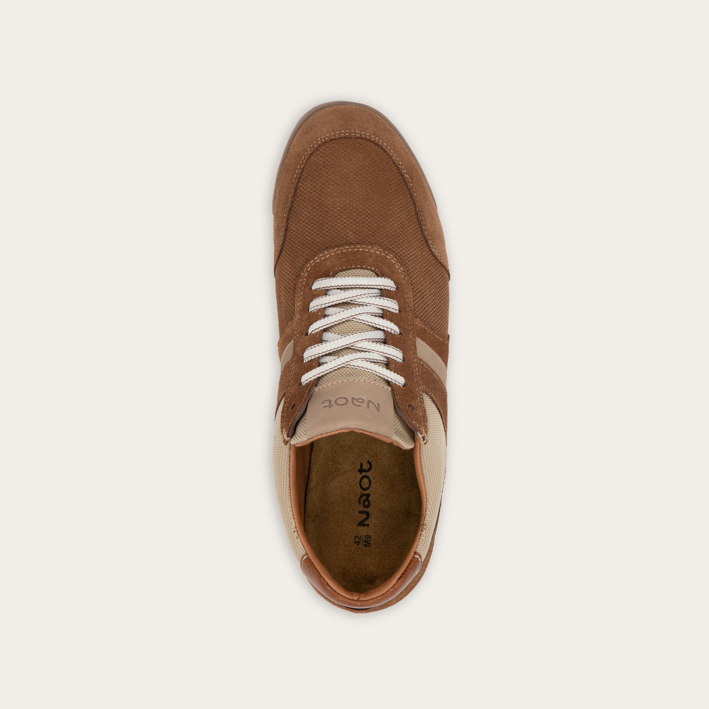 Top view of a brown and beige sneaker  on a brown sole.