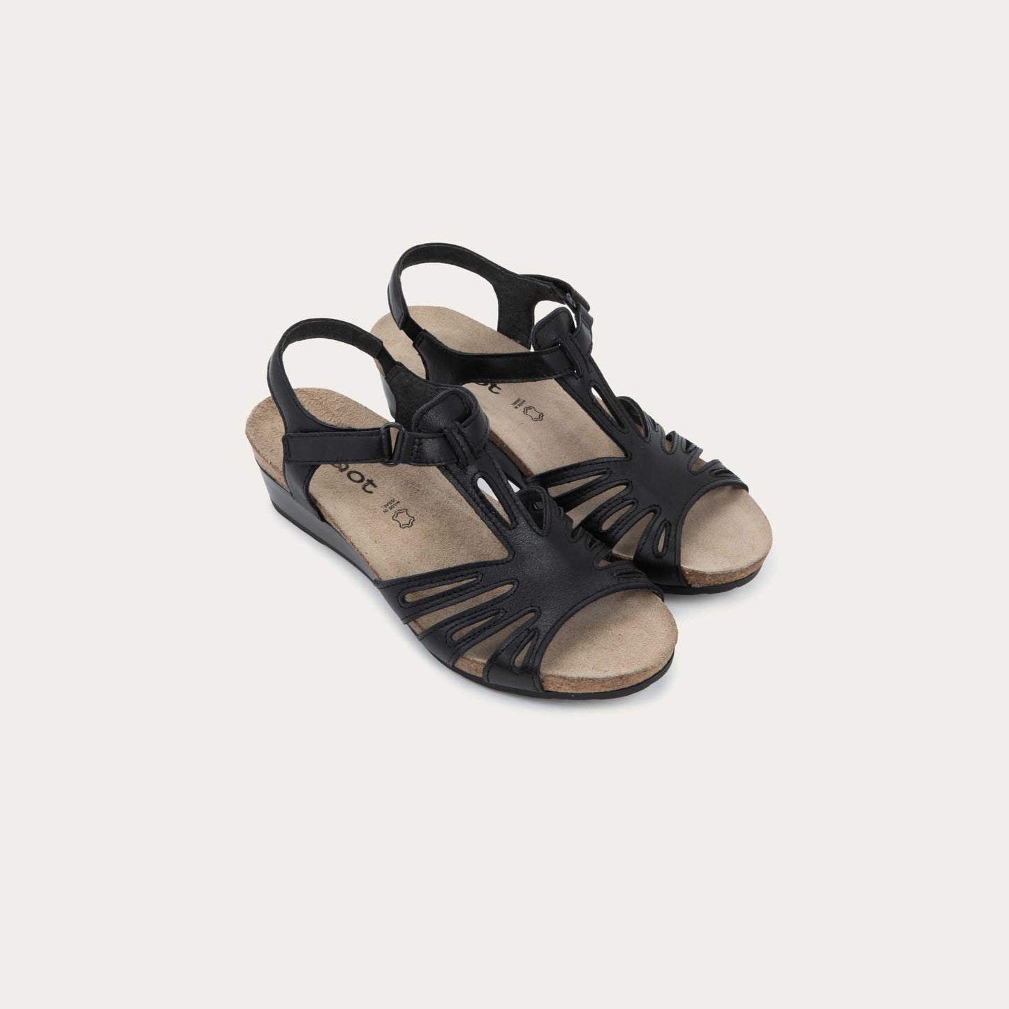 A pair of black wedge sandals with strappy design, open toe, and adjustable ankle strap on a cork footbed.