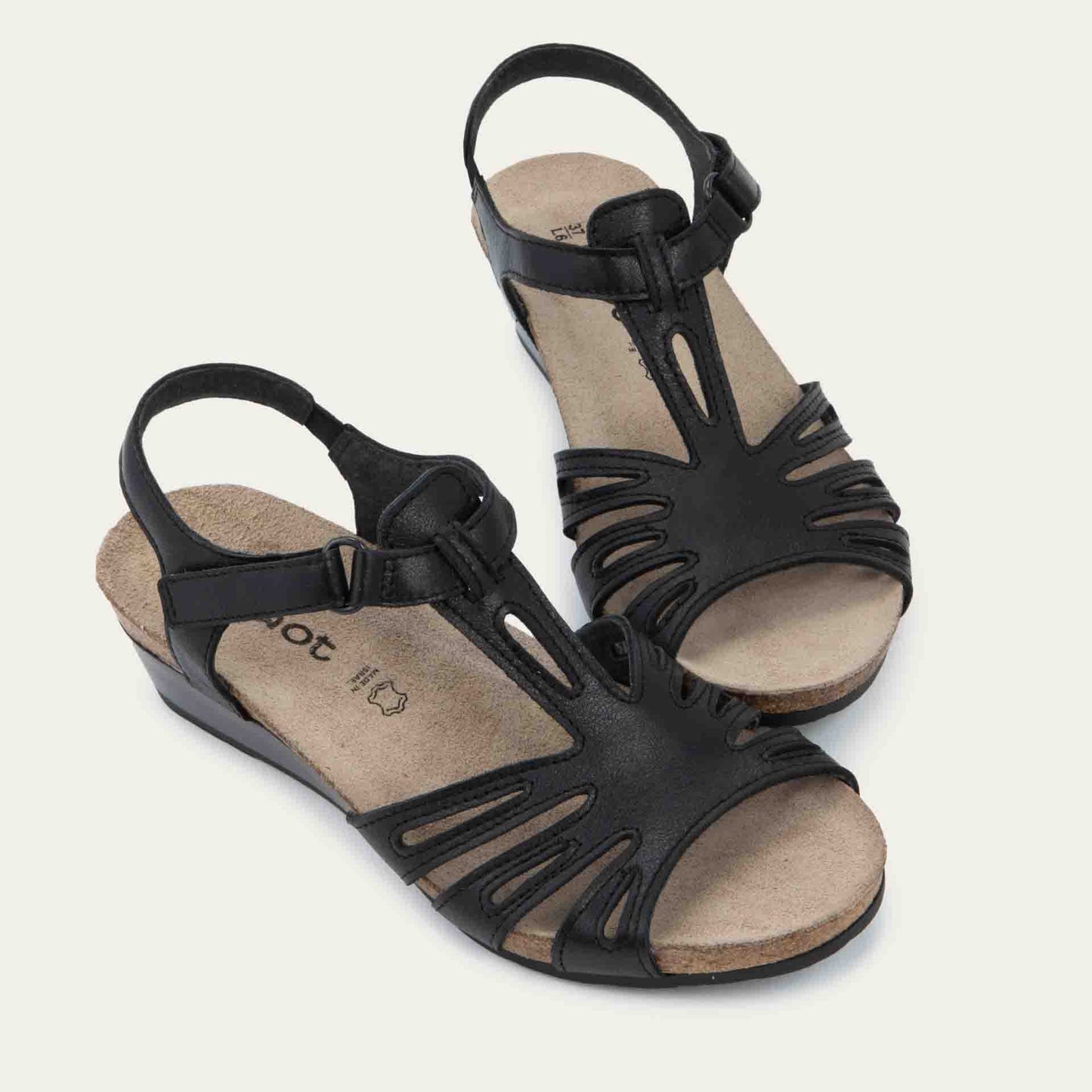 A pair of black wedge sandals with strappy design, open toe, and adjustable ankle strap on a cork footbed.