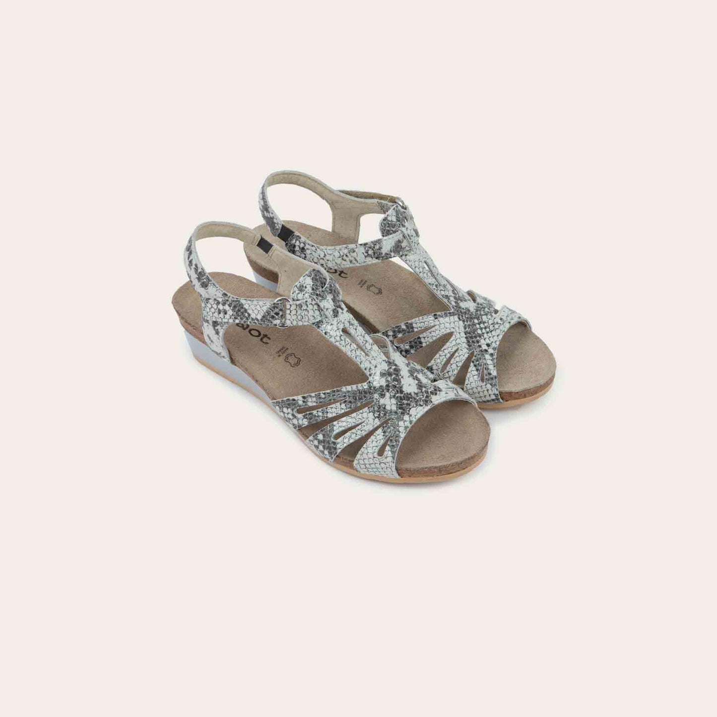 A pair of black wedge sandals with strappy design, open toe, and adjustable ankle strap on a cork footbed.