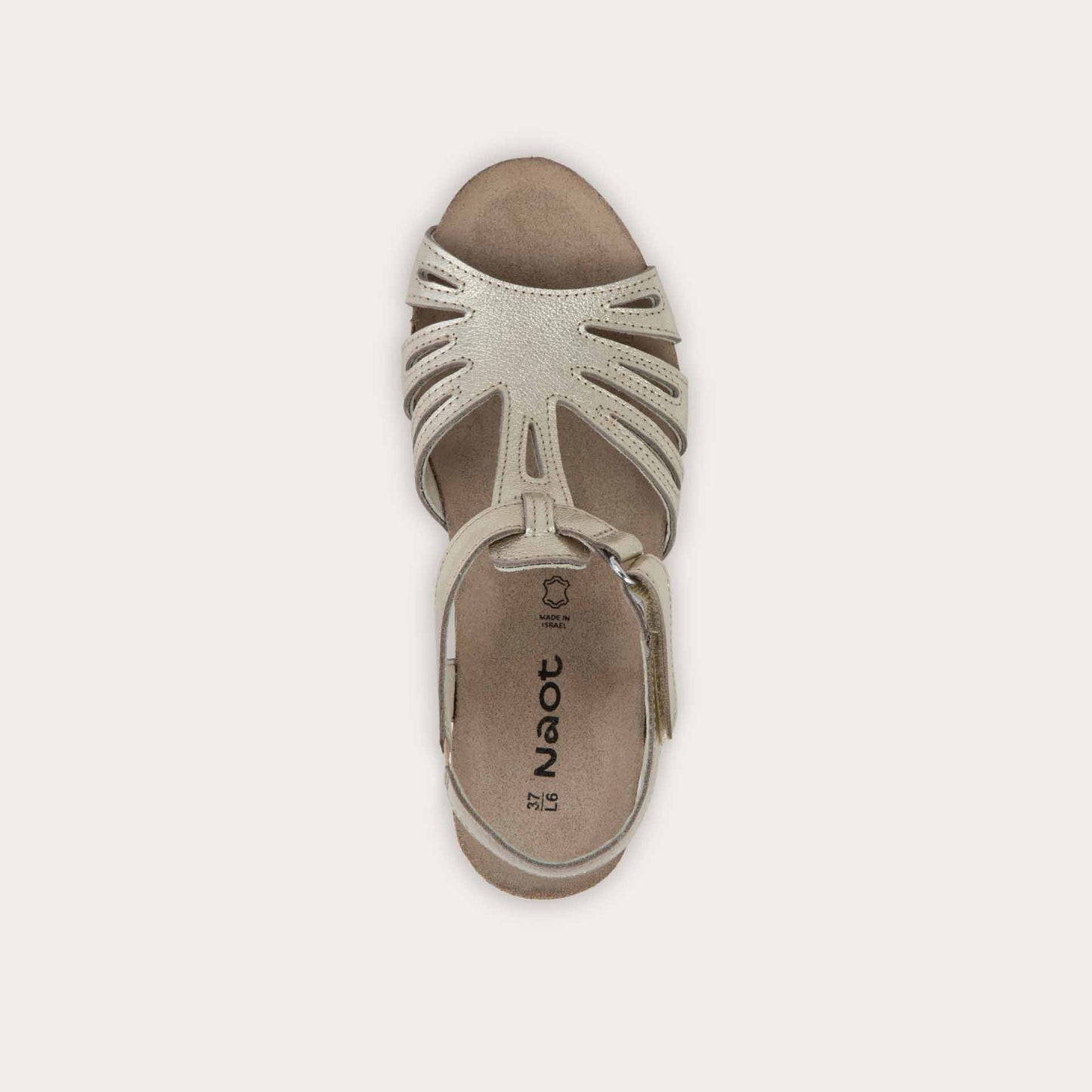 Bottom view of a gold wedge sandal with strappy design, open toe, and adjustable ankle strap on a cork footbed.