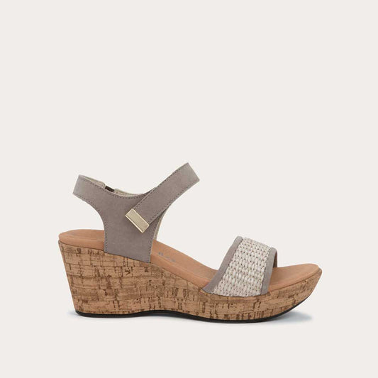 Profile view of a wedge heeled sandal with a gray leather ankle strap, and woven beige front strap