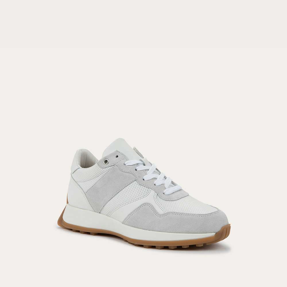 Angled profile view of a multi-material white lace up sneaker.