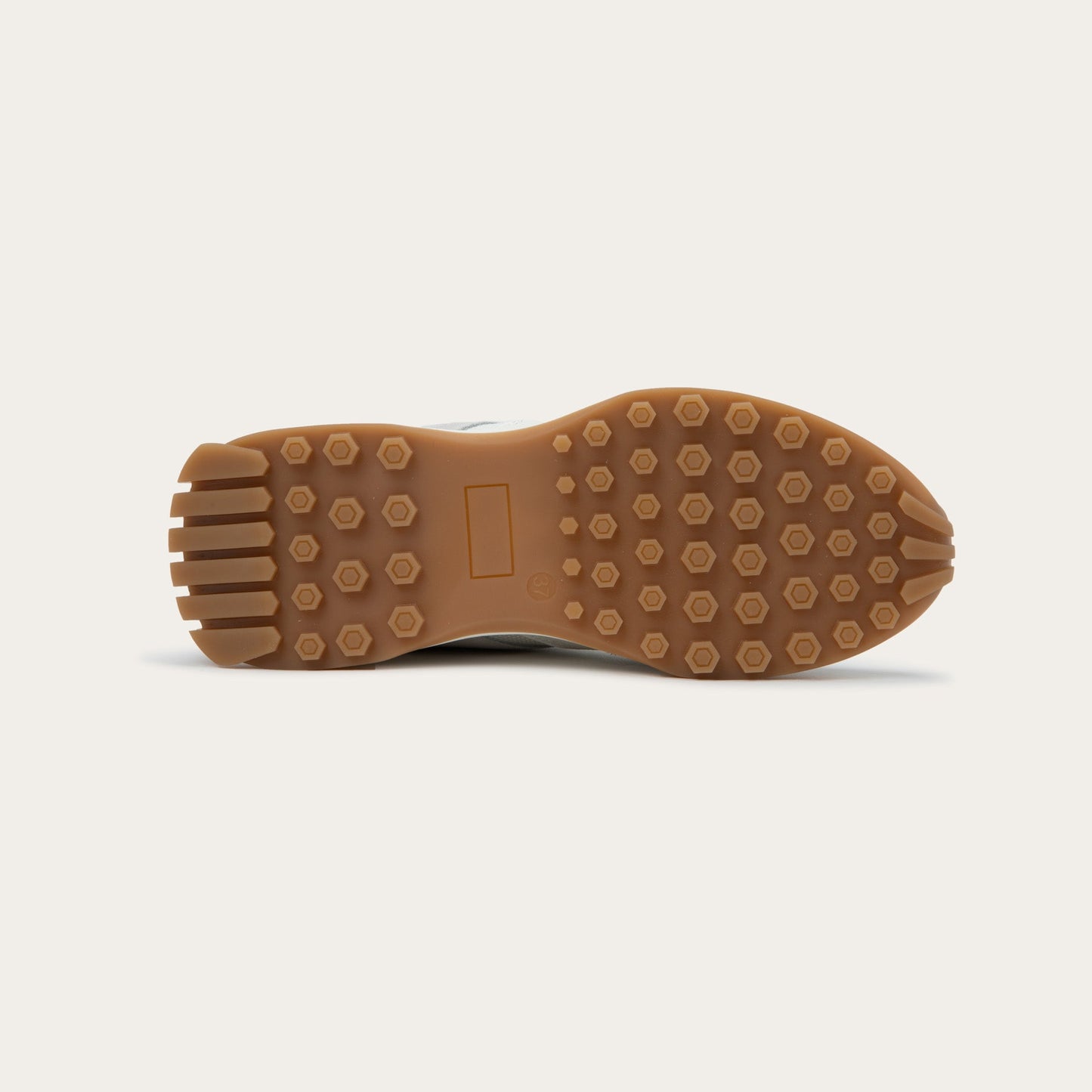 Bottom view of a multi-material white lace up sneaker.