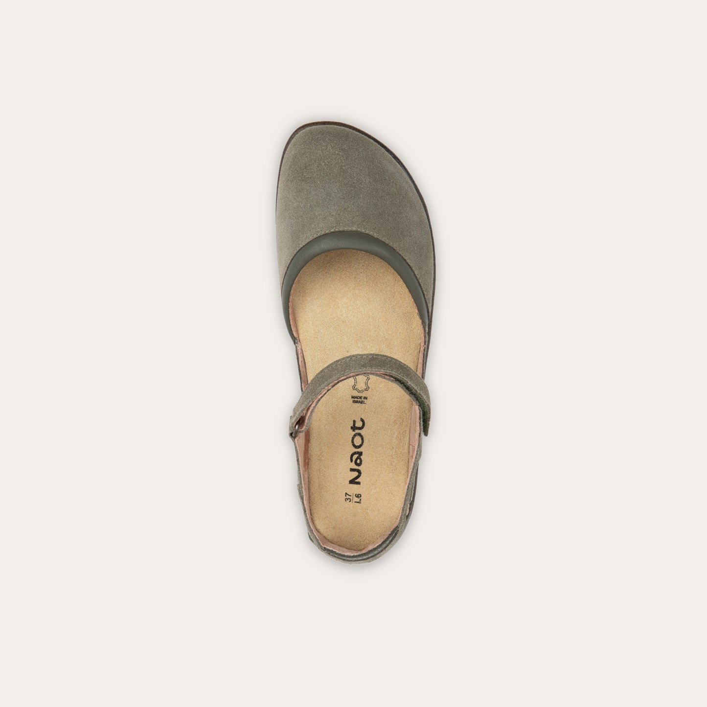 Top view of a green Mary Jane featuring contrasting materials and cutouts by the heel on a dark sole.