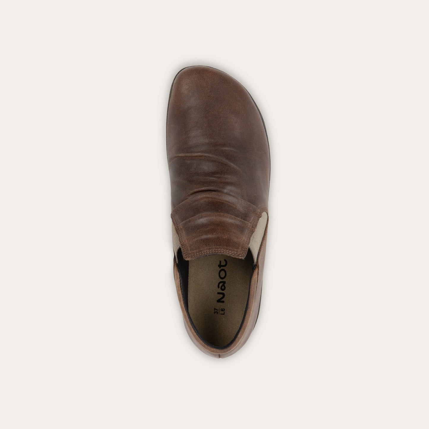 Top view of a brown leather ankle boot with a textured sole.