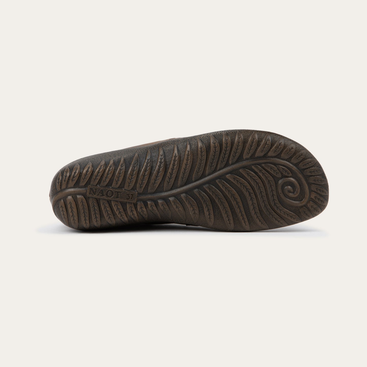 Bottom view of a brown leather ankle boot with a textured sole.