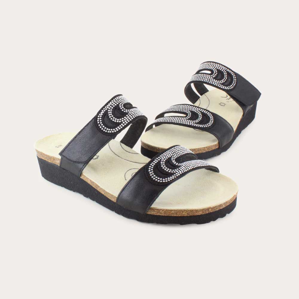 A pair of  black leather slip on wedge sandals with two straps and reivet detailing on a cork footbed,