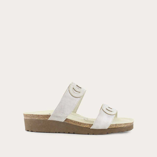 Profile view of a black sandal with an open toe and slingback design featuring adjustable straps and cut-out details.