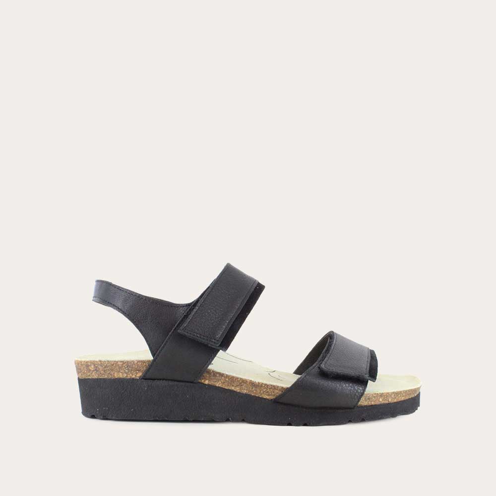 Profile view of a black leather sandal with two adjustable straps and a cork platform sole.