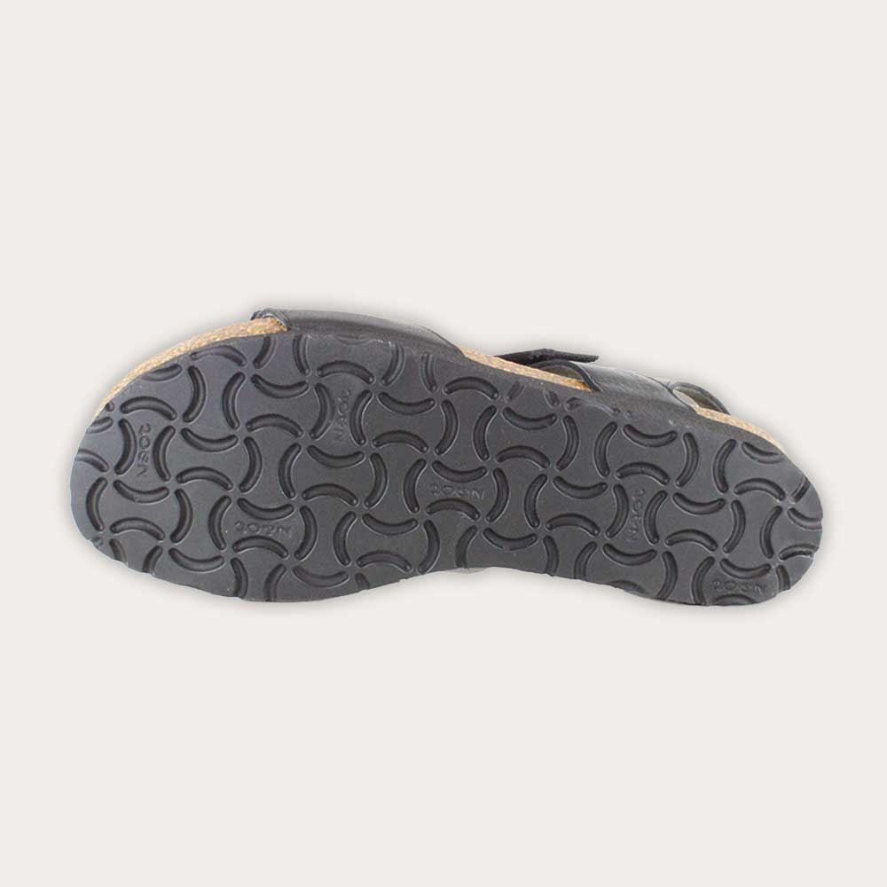 Bottom view of a black leather sandal with two adjustable straps and a cork platform sole.