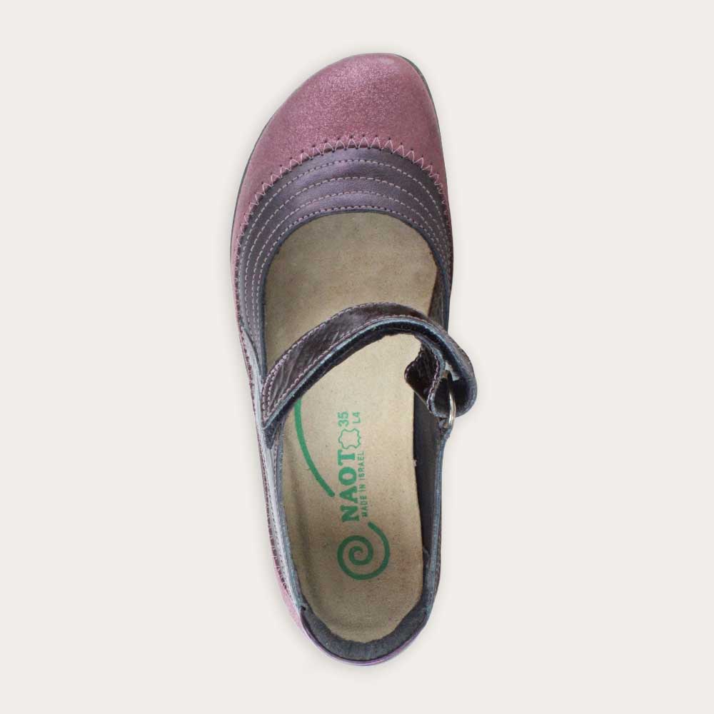 Top view of a purple mary jane featuring contrasing shimmer suede and shiny leather on a black sole.